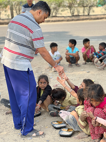 Volunteer distributing food to children